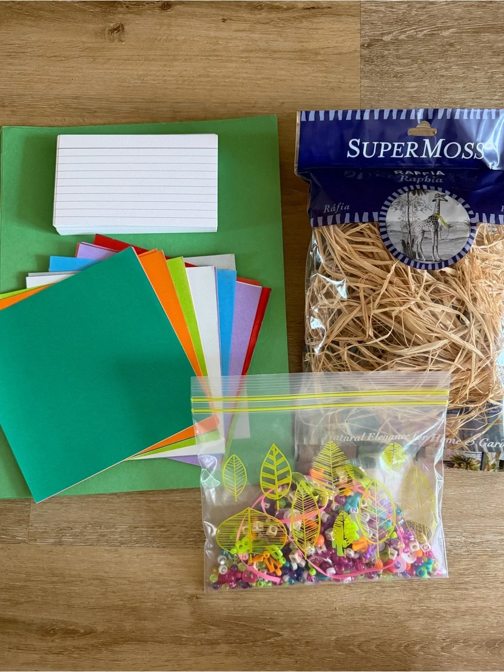Variety craft supplies, origami, raffia, beads, open package
